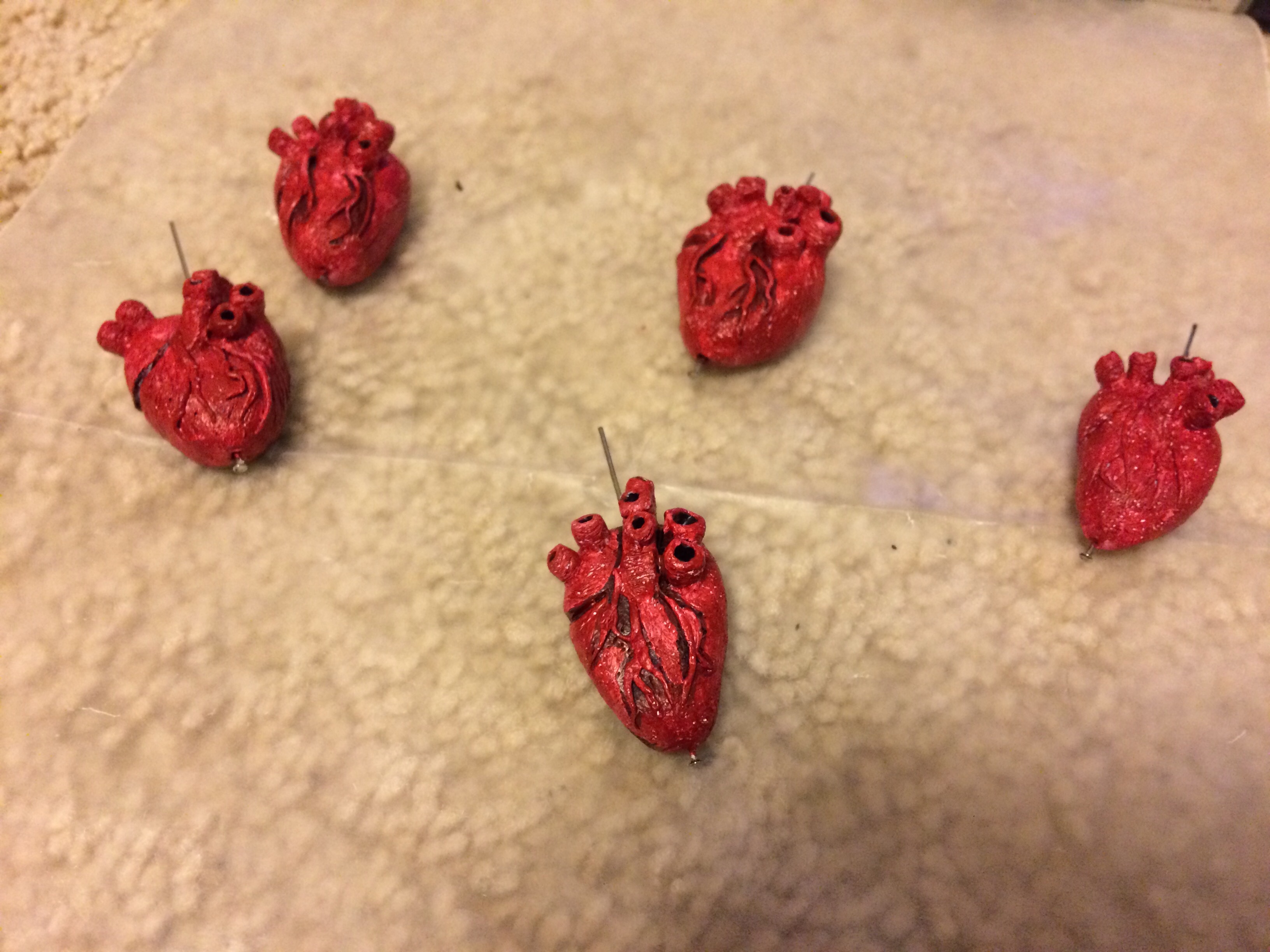 Painted human heart pendants